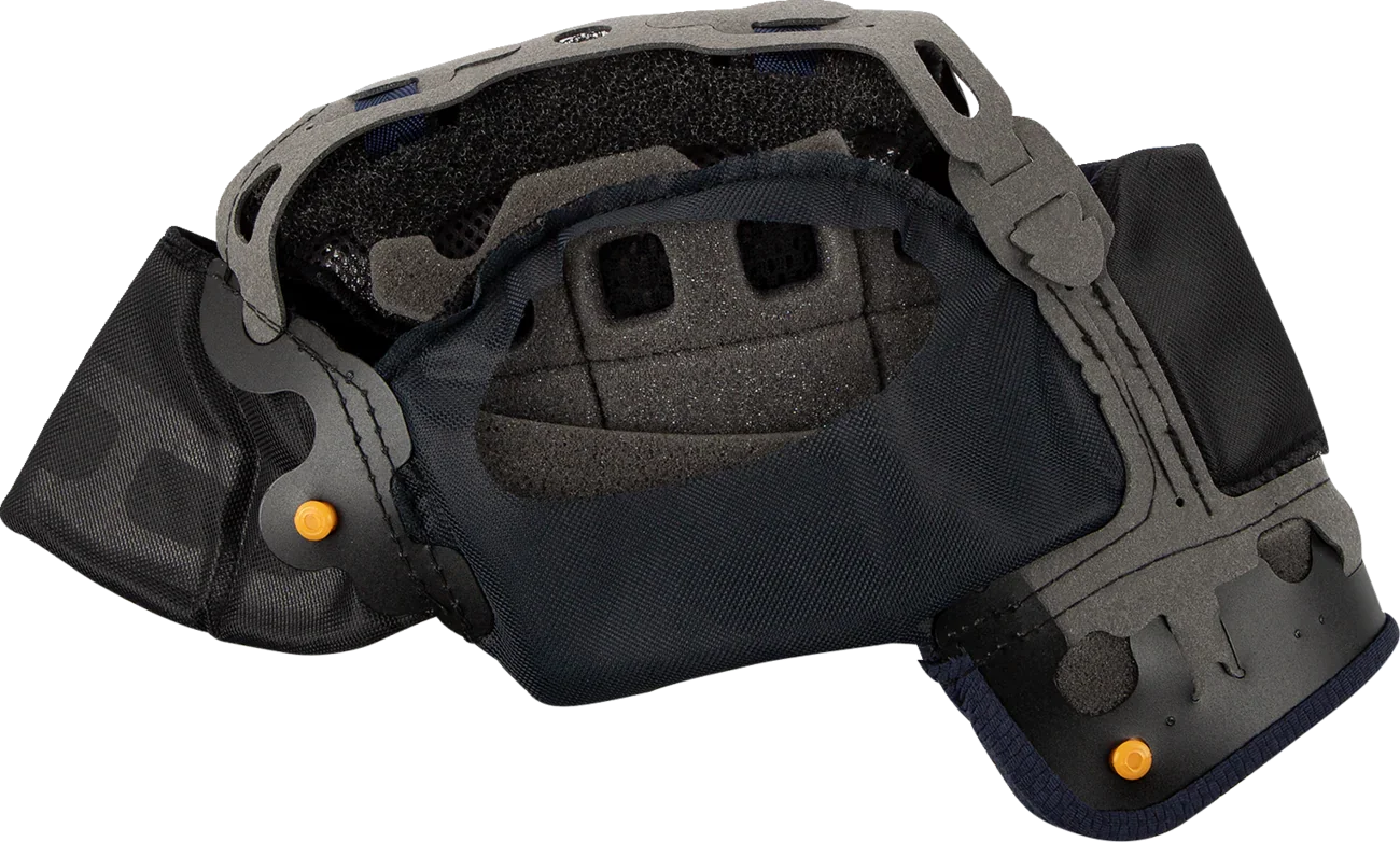 Black motorcycle helmet interior with padded lining, ventilation holes, and orange adjustment knobs for comfort and fit.