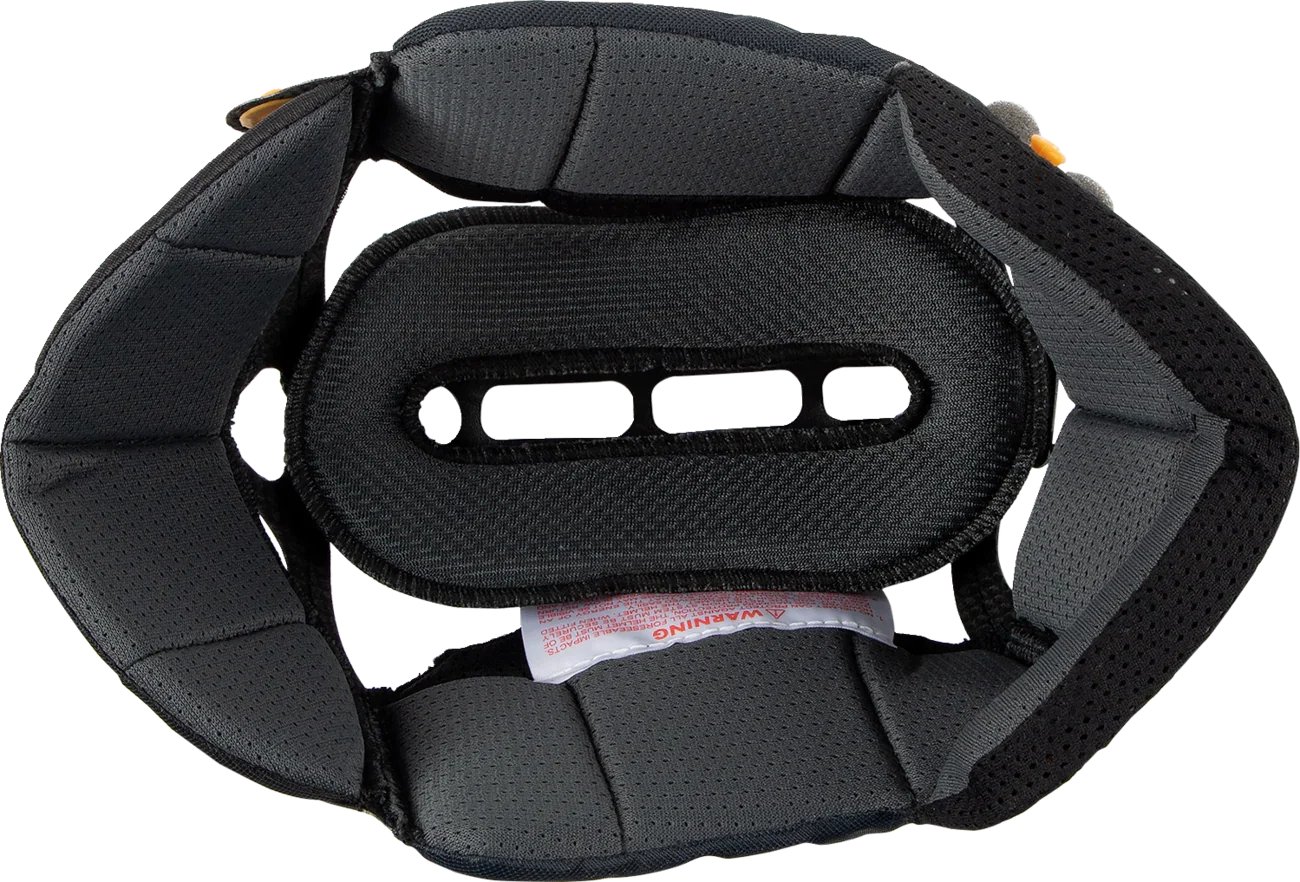 Black motorcycle helmet interior padding with ventilation slots and warning label