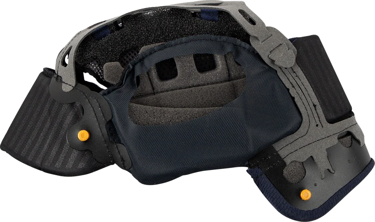 Motorcycle helmet interior with padded lining, ventilation slots, and adjustable chin strap for comfort and safety.