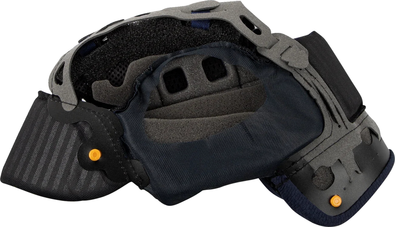 Motorcycle helmet interior with black padding, ventilation holes, and orange adjustment knobs for comfort and fit.