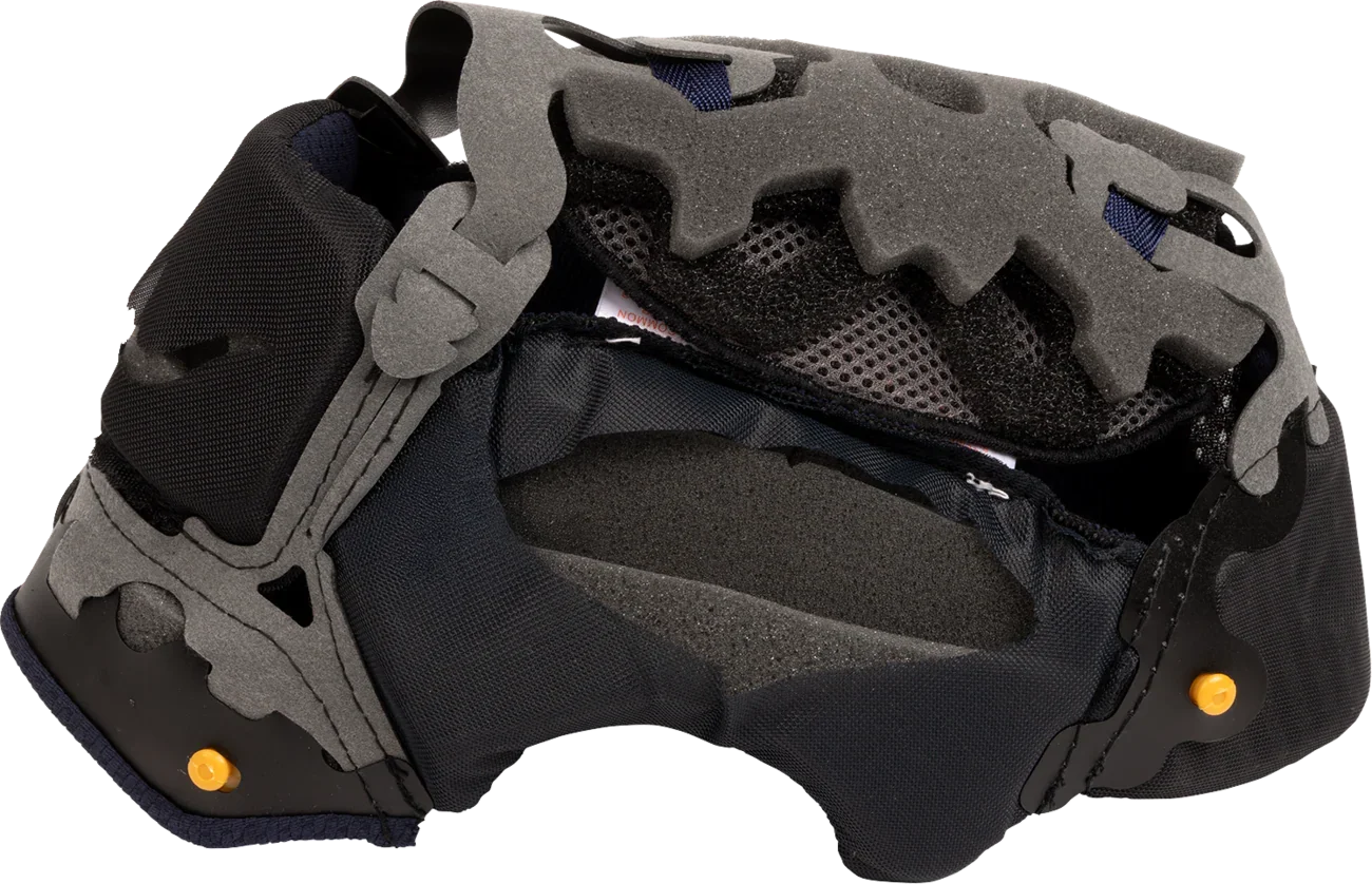Motorcycle helmet interior with gray foam padding, black mesh lining, and yellow adjustment pins for comfort and fit.