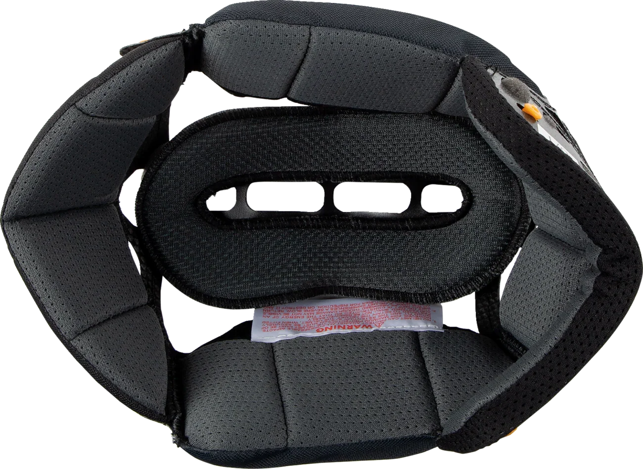 Black motorcycle helmet interior padding with ventilation slots and warning label